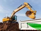 Caterpillar 320GC crawler excavator loading a truck