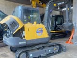 2023 Volvo EC60DLC mini excavator, three-quarter view
