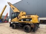 2008 Caterpillar M325D MH material handler, rear three-quarter view