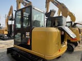 2024 Caterpillar 305.5E2 mini excavator, rear three-quarter view