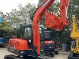 2023 Doosan DX55-9C mini excavator, rear three-quarter view