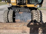 2008 Caterpillar M318D wheel excavator front view with dozer blade