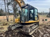 2021 Caterpillar 313 crawler excavator, front three-quarter view