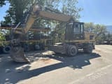 2014 Caterpillar M318D wheel excavator, front three-quarter view