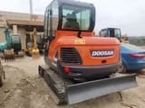 Doosan DX60 crawler excavator, rear three-quarter view