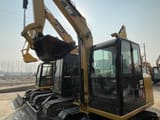 2024 Caterpillar 305.5E2 mini excavator, front three-quarter view