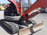 JCB 5 T235 mini excavator, rear three-quarter view with engine compartment open