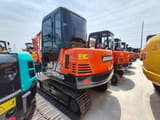 2024 Doosan DH55 mini excavator, rear three-quarter view
