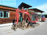 2015 Kobelco SK55SRX-6 mini excavator, side view with attachments