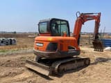 2023 Doosan DX55-9C mini excavator, rear three-quarter view