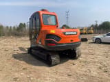 2024 Doosan DX75-9C mini excavator, rear three-quarter view