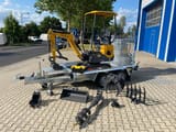 Berger Kraus BK1000JS mini excavator on a trailer with attachments
