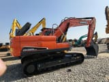 2024 Doosan DX225LCA crawler excavator, rear three-quarter view