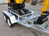 JPC HT-12 mini excavator on a trailer, rear three-quarter view