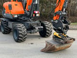 2017 Doosan DX57W wheel excavator, side view with attachment