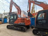 2023 Doosan DX140 excavator, side view