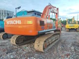 Hitachi ZX210 crawler excavator, rear three-quarter view