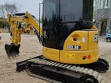 2023 Caterpillar 303.5E mini excavator, rear three-quarter view