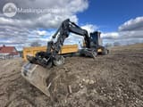 2016 Volvo EW160E wheel excavator, side view with trailer