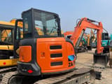 2025 Hitachi ZX55 mini excavator, rear three-quarter view