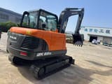 2026 Doosan DX60D mini excavator, rear three-quarter view
