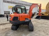 2023 Doosan DX60-9C crawler excavator, rear three-quarter view