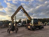 2012 Caterpillar M318 MH wheel excavator, front three-quarter view