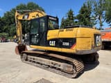 Excavadora de orugas Caterpillar 320DL 2010, vista trasera tres cuartos