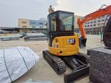 2023 Caterpillar 303.5E mini excavator, rear three-quarter view