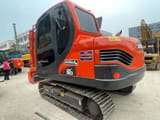 2023 Doosan DX80 mini excavator, rear three-quarter view