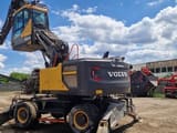 2018 Volvo EW240EMH material handler, rear three-quarter view