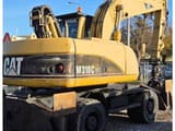 2006 Caterpillar M318CMH wheel excavator, rear three-quarter view