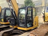 2019 Caterpillar 310 crawler excavator, side view of cab