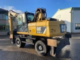2012 Caterpillar M318D MH material handler, rear three-quarter view