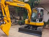 2024 Komatsu PC78US mini excavator, front three-quarter view