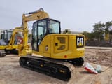 Caterpillar 310 mini excavator, rear three-quarter view