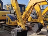 2023 Komatsu PC55MR mini excavator, front three-quarter view