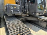 2023 Volvo EC140 crawler excavator side view of the undercarriage and cab