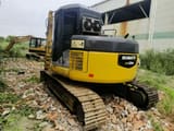 Komatsu PC128US excavator, rear three-quarter view