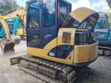 2022 Caterpillar 306E2 excavator, rear three-quarter view with engine cover open