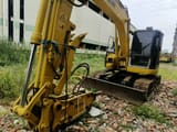 Komatsu PC128US excavator with hydraulic breaker attachment