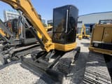 2024 Caterpillar 304CR mini excavator, front three-quarter view