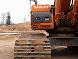 Doosan DX225LC crawler excavator side view of tracks and body