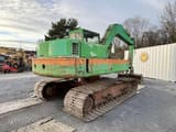 1985 Poclain 90 crawler excavator, rear three-quarter view