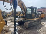 2024 Caterpillar 315D2L crawler excavator with auger attachment, side view