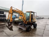 1990 Komatsu PW30-1 wheel excavator, front three-quarter view