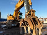 2013 Hyundai R800LC-9 crawler excavator, front three-quarter view with grapple attachment