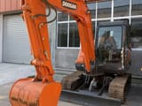 Doosan DX60-9C mini excavator, front three-quarter view