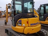 2024 Komatsu PC55MR-5 mini excavator, rear three-quarter view