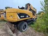 2012 Caterpillar M322D wheel excavator, rear three-quarter view